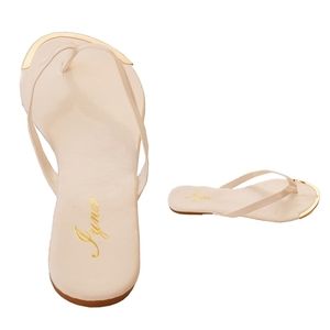 New white flip flops with gold metal tip